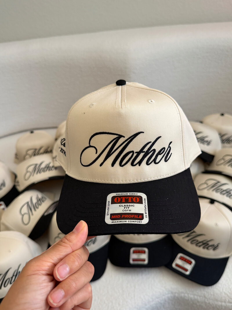 Custom embroidered Mother script logo on cream and black snapback hat by Colorblox Merch in Gilbert Arizona